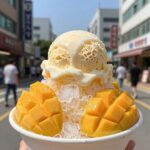 공릉 커피콩의 대표 망고빙수 사진. 얼음산에 망고가 가득 붙어 있고 아이스크림이 올려져 있다.